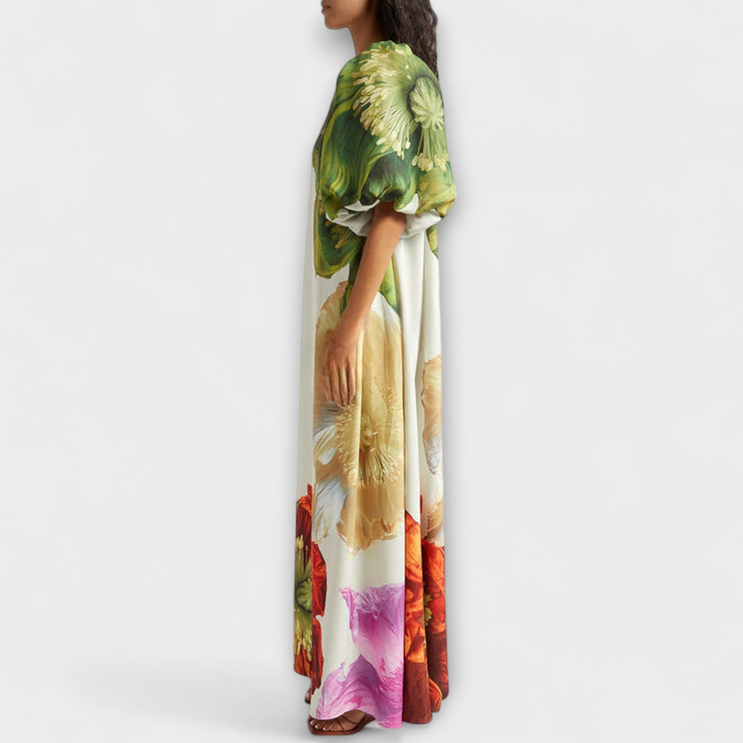 Stylish women's floral maxi dress in green, featuring an elegant asymmetrical neckline & puff sleeves.