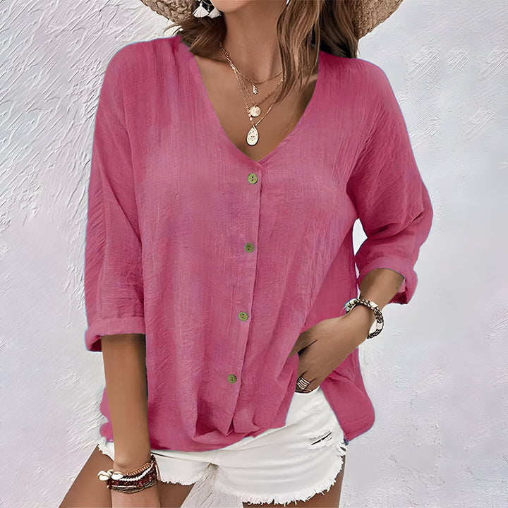 Purple women's relaxed fit V-neck button-up blouse. Comfortable elbow sleeve top for effortless style.