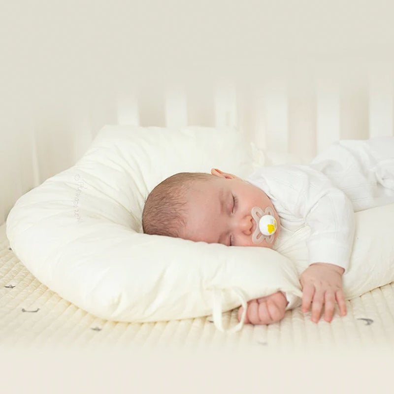 Baby organic cotton head support pillow, U-shape for gentle sleep, newborn comfort essential.