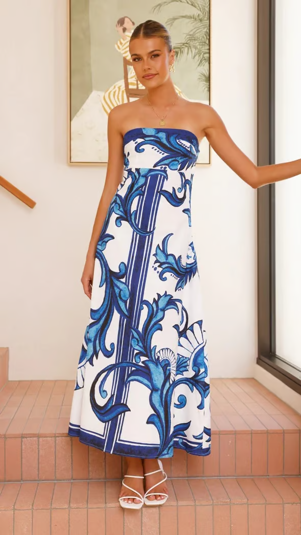 Chic women's short sleeve flowy printed dress, versatile for casual wear or elegant occasions. Summer fashion.