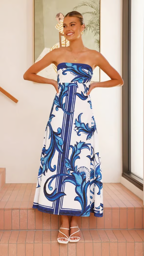 Elegant women's printed flowy midi dress with short sleeves, perfect for summer fashion or a wedding guest.