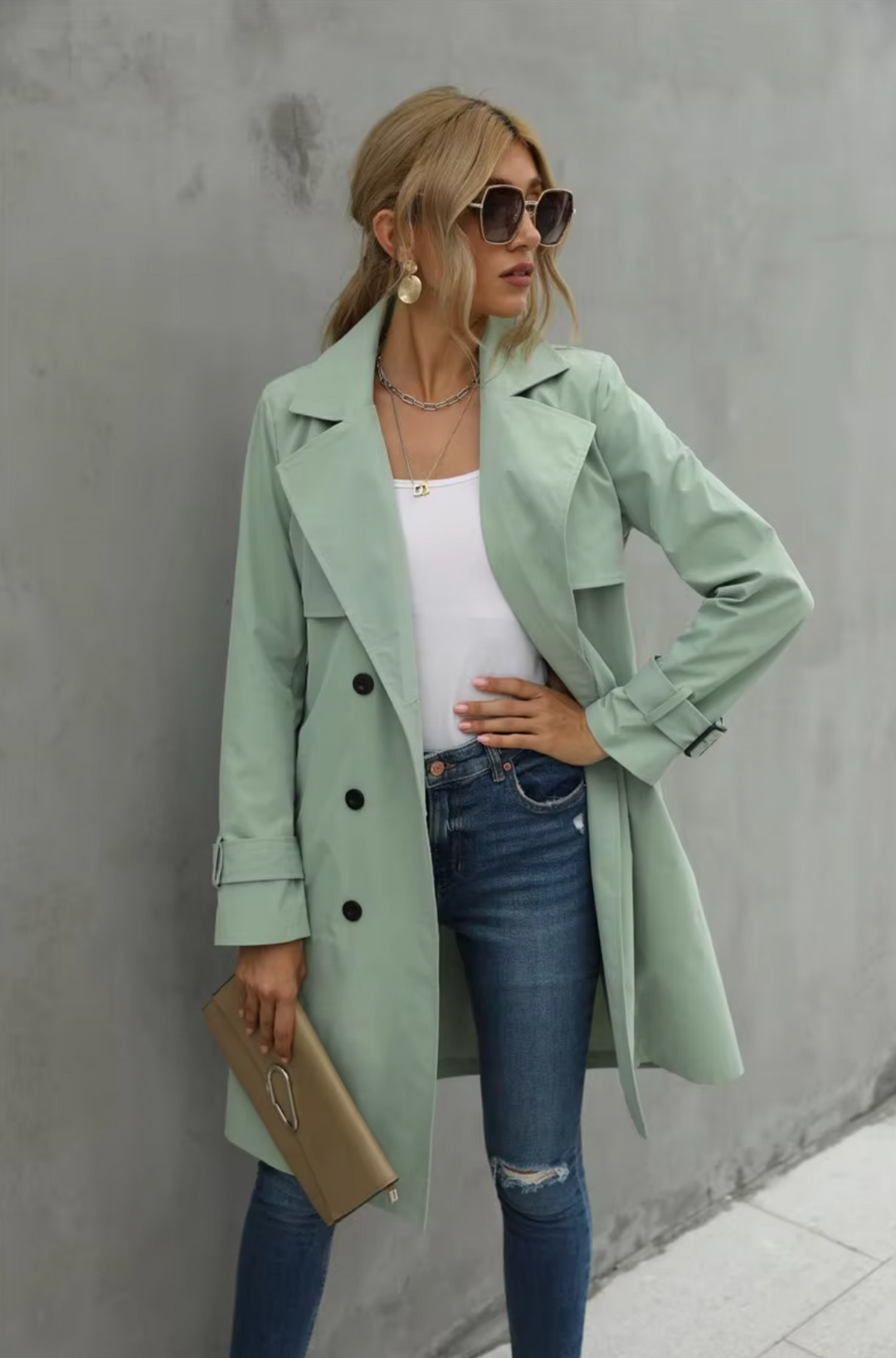 Fashionable women's double-breasted khaki trench coat with adjustable belt, essential fall outerwear