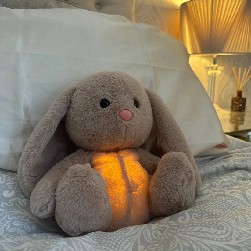 Plush animal sleep aid; a charming nursery decor piece with built-in soothing sounds and gentle light features.