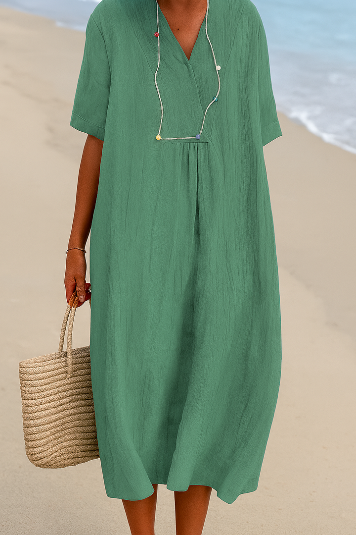 Flowy yellow green women's summer beach dress with a relaxed V-neck and short sleeves. Ideal for resorts.