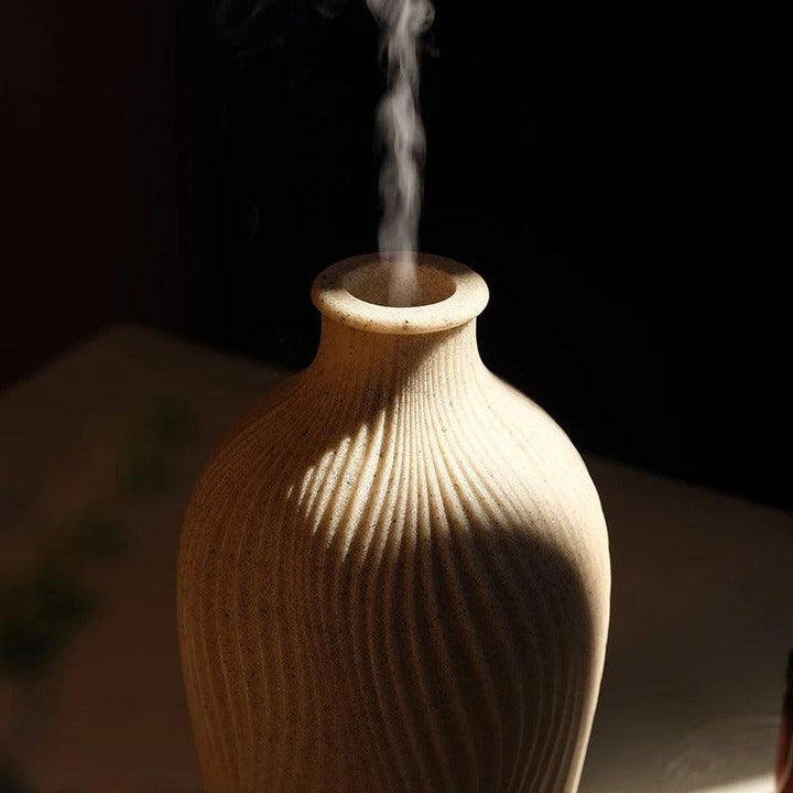 Modern home aromatherapy diffuser, humidifier for living room, enhances wellness & decor appeal.