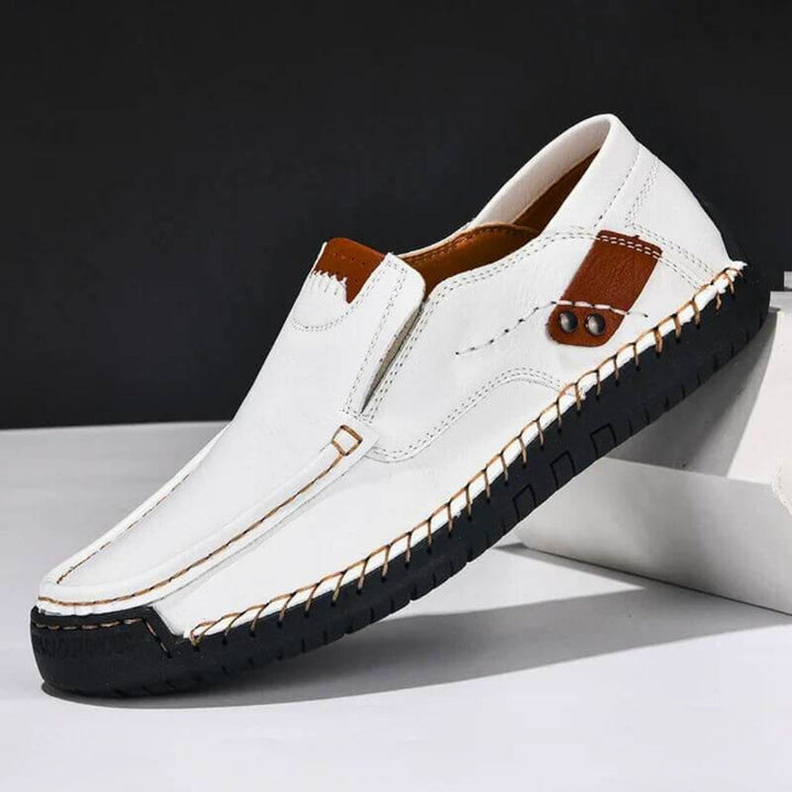 Men's white slip-on footwear providing robust arch support & maximum comfort, great for easy wear and foot relief.
