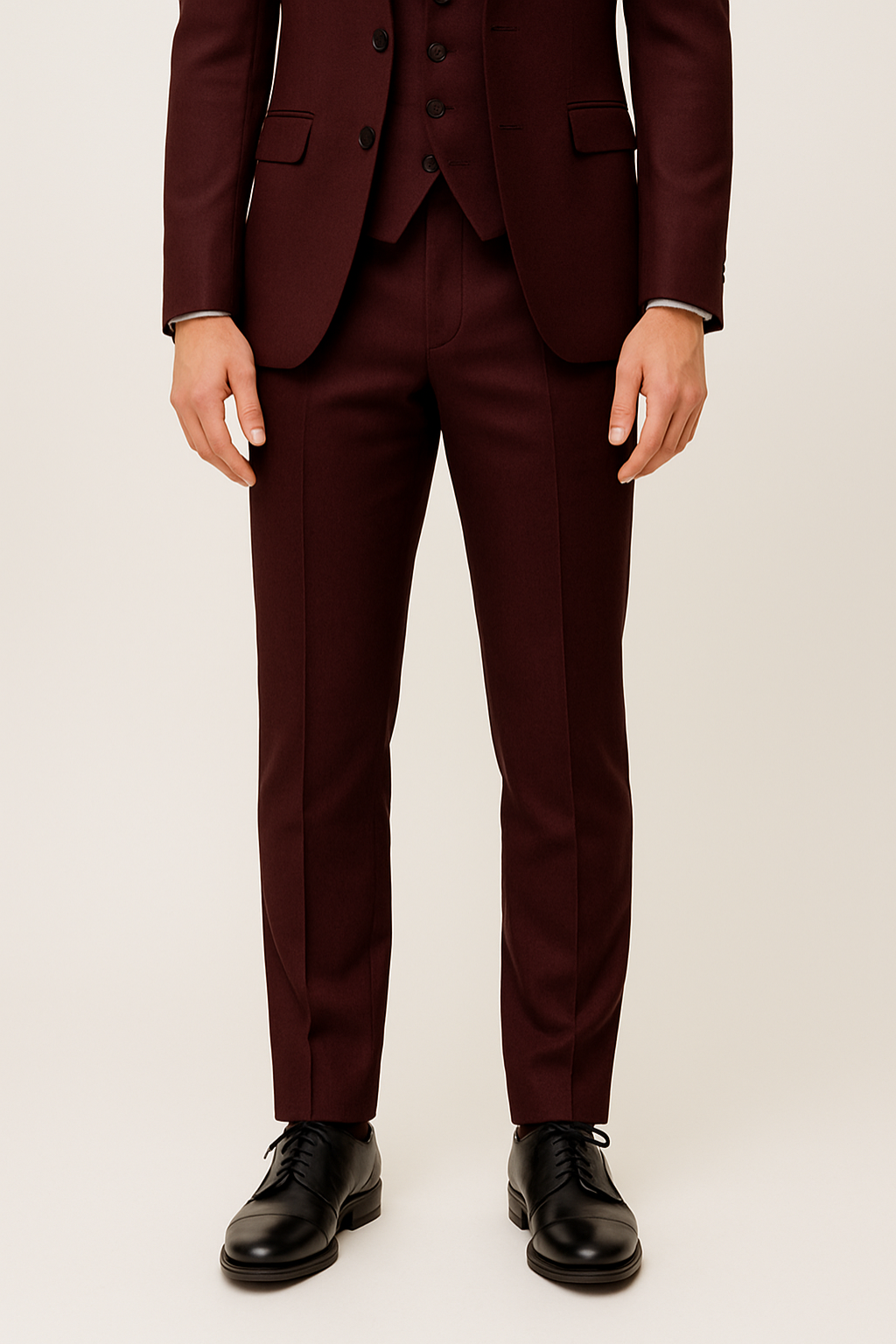 Full shot of a men's apparel burgundy suit, complete with trousers, vest, and jacket; formal wear.