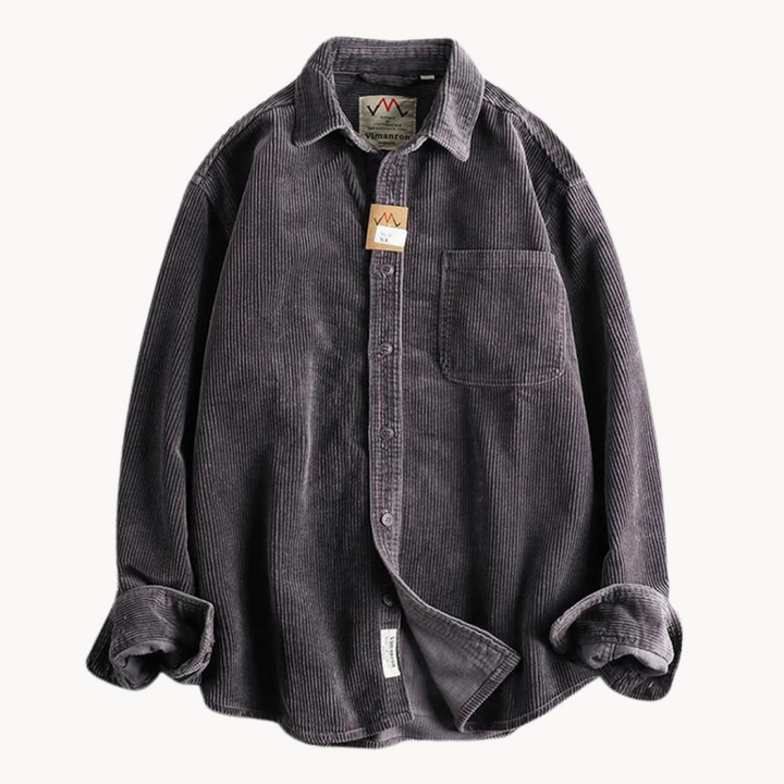Stack of folded men's corduroy long sleeve button-down shirts in various colors, great for autumn/winter.