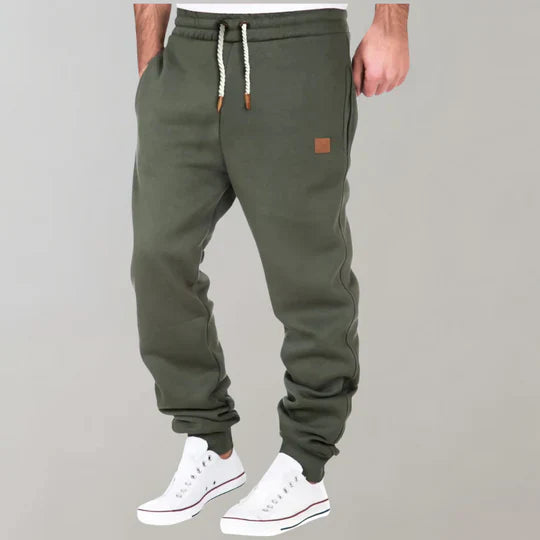 Men's casual jogging pants in dark grey, featuring an elastic waist and drawstring for ultimate comfort.