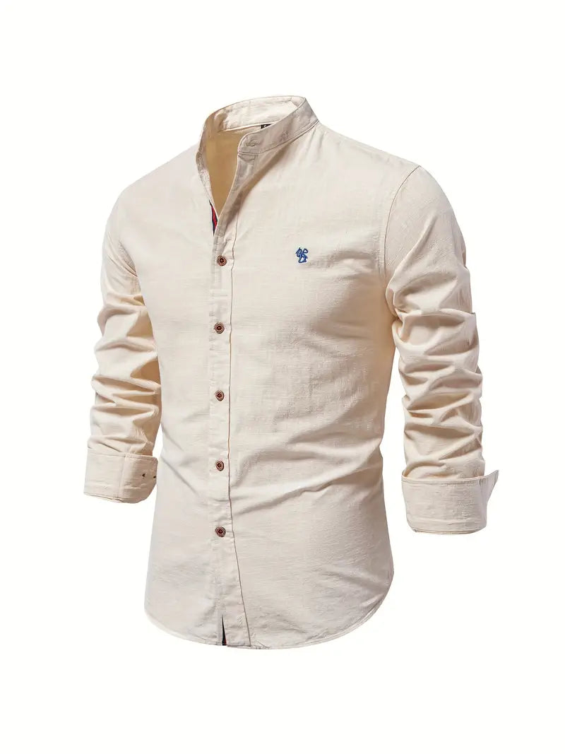 Man wearing a relaxed fit men's button-down shirt with sleeves rolled up, showcasing spring style.