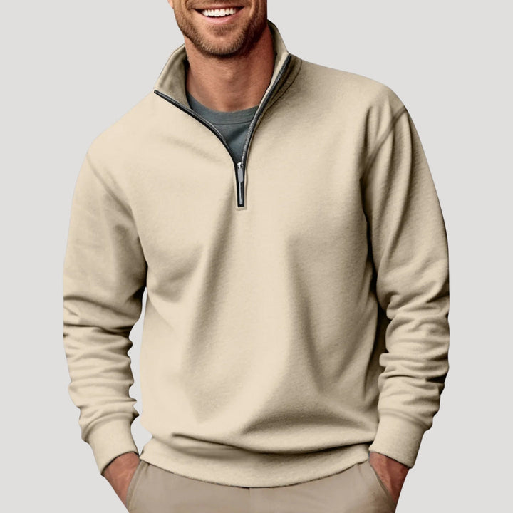 Close-up of quarter-zip detail on a men's gray long-sleeve pulley, showing collar