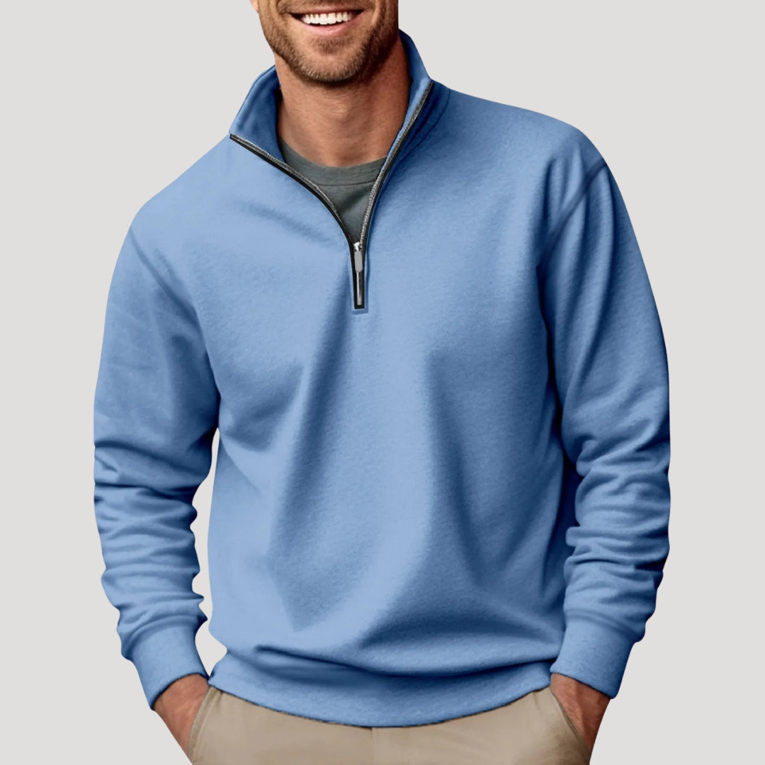 Stack of folded men's quarter-zip sweatshirts in various colors, ready for layering