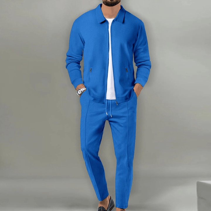 Black men's tracksuit comprising a zip-up jacket and joggers, designed for both fashion and sportswear.