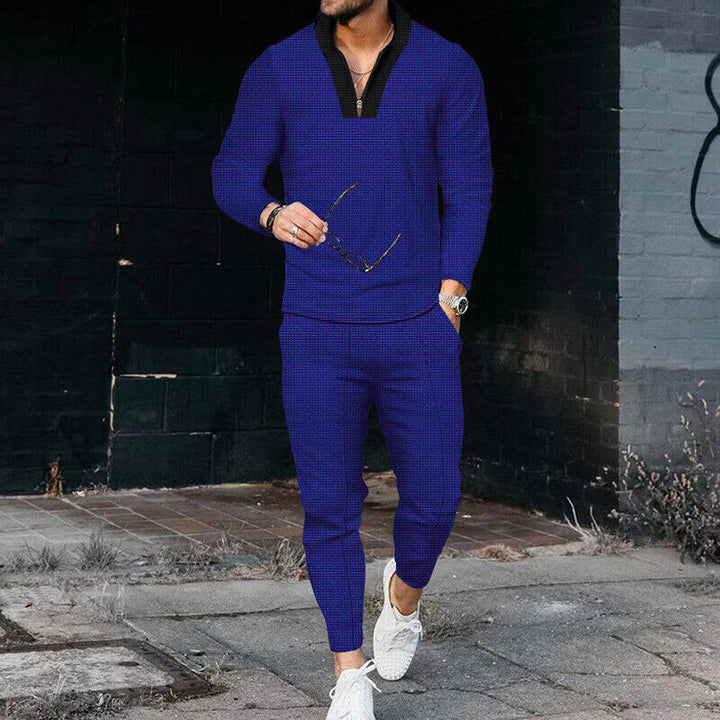 Full body view of a man wearing a stylish two-piece tracksuit, ideal for casual outings.