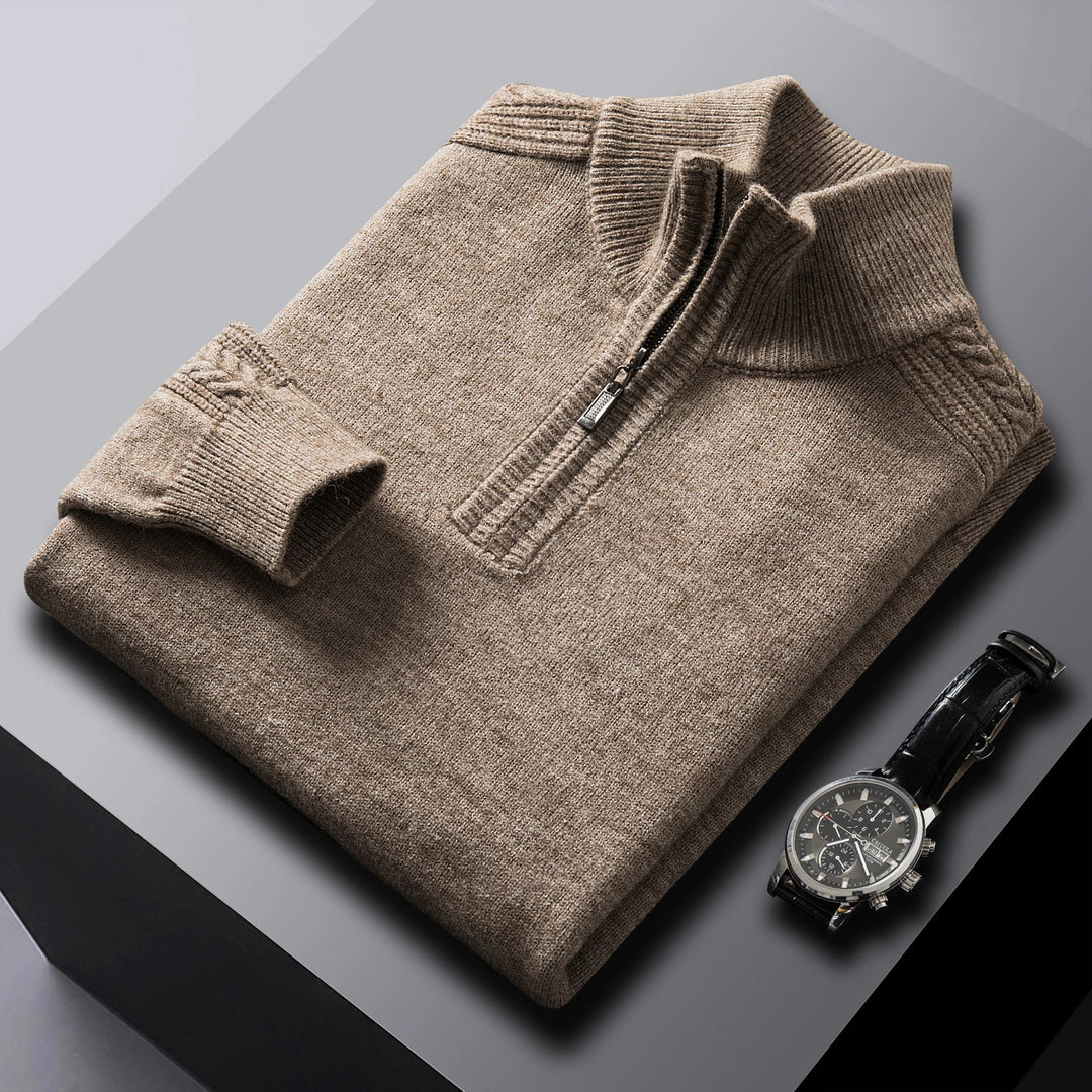Close-up of a men's cable knit quarter-zip sweater, highlighting the intricate knitted pattern and texture.