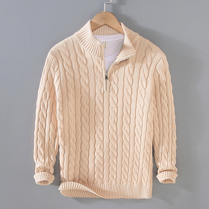 Close-up of the intricate cable knit texture on a men's half-zip long sleeve sweater