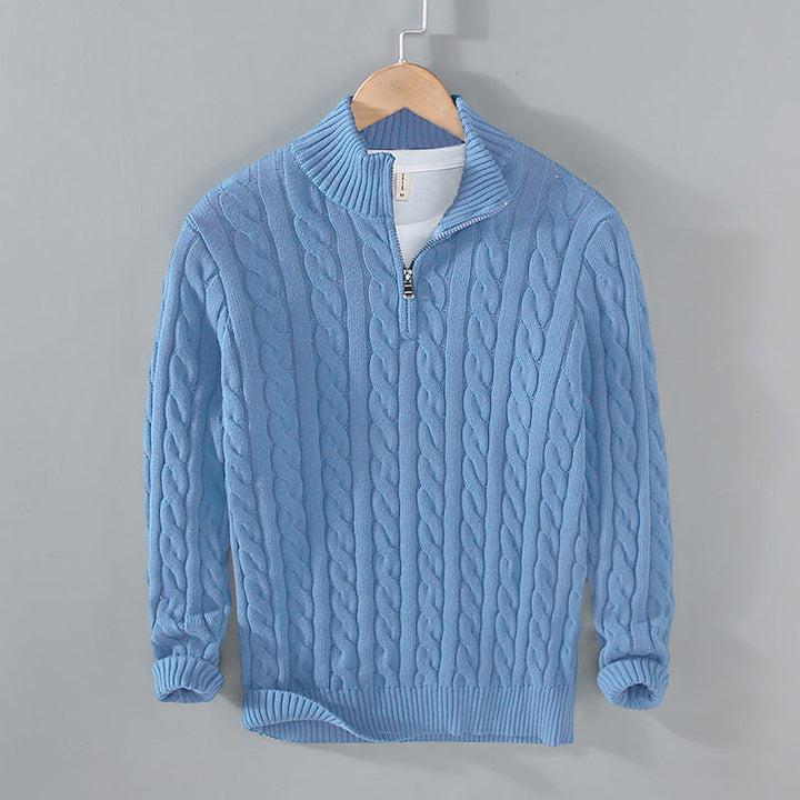Detail of the zipper and collar on a men's textured half-zip cable knit sweater