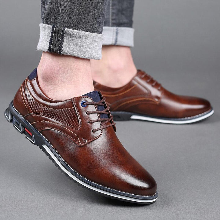 Close-up of men's formal-casual lace-up shoes, highlighting the anti-slip tread and quality stitching.