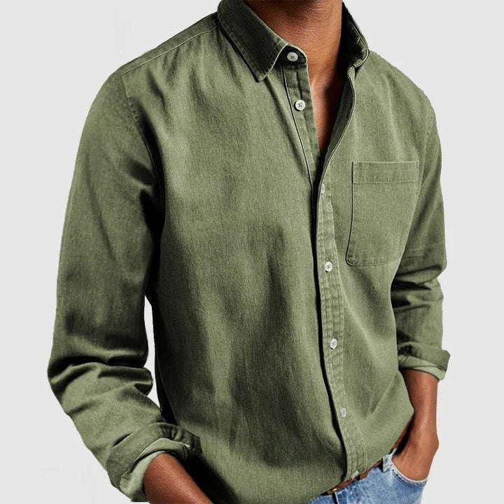 Close-up of men's classic long sleeve button down shirt, showing collar, buttons, & chest pocket details.