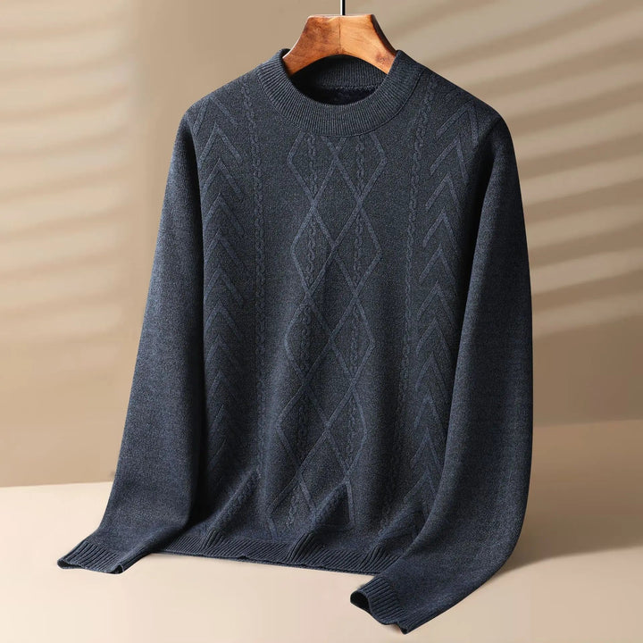 Close-up of a men's grey cable knit crewneck sweater, highlighting the intricate knitted pattern.