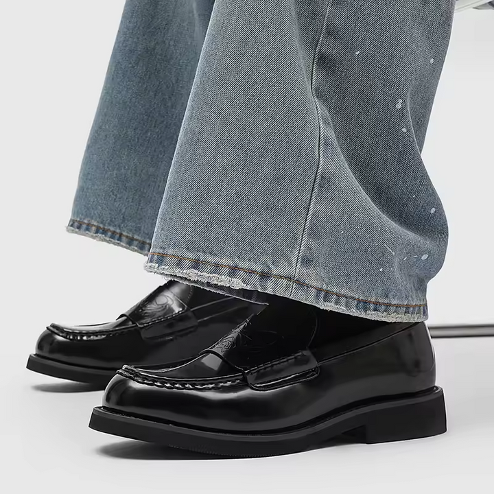 Comfortable men's loafers featuring a polished black leather finish. Versatile classic shoes for everyday wear & formal.