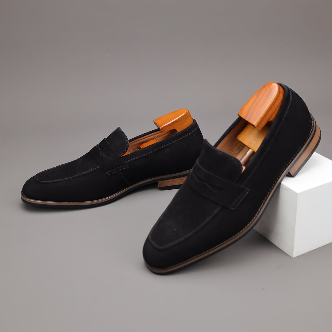 Detailed view of men's elegant brown leather slip-on loafers, showcasing fine stitching & material quality.