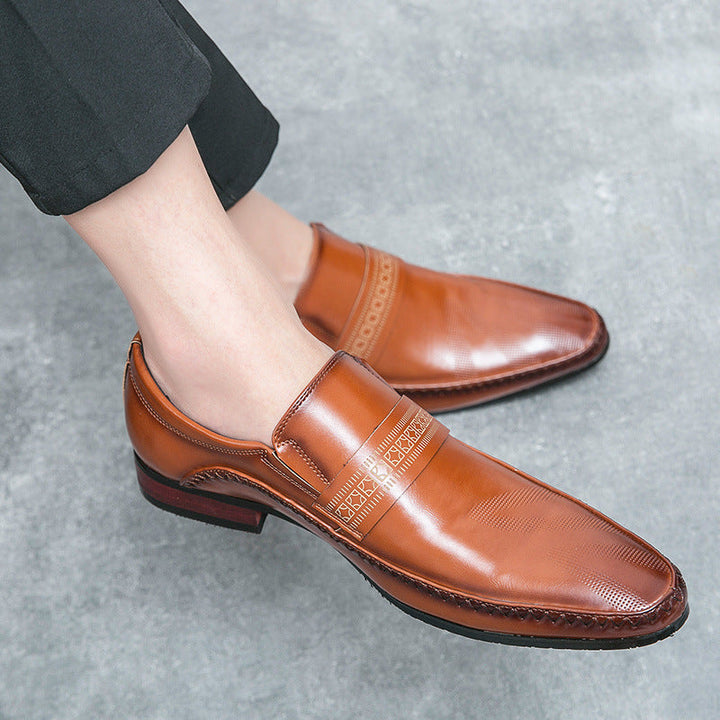 Black leather men's penny loafers, offering a timeless slip-on design for sophisticated casual or dress looks.