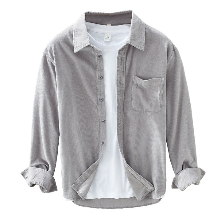Textured men's button-up shirt with a chest pocket, featuring long sleeves, great for casual spring style.