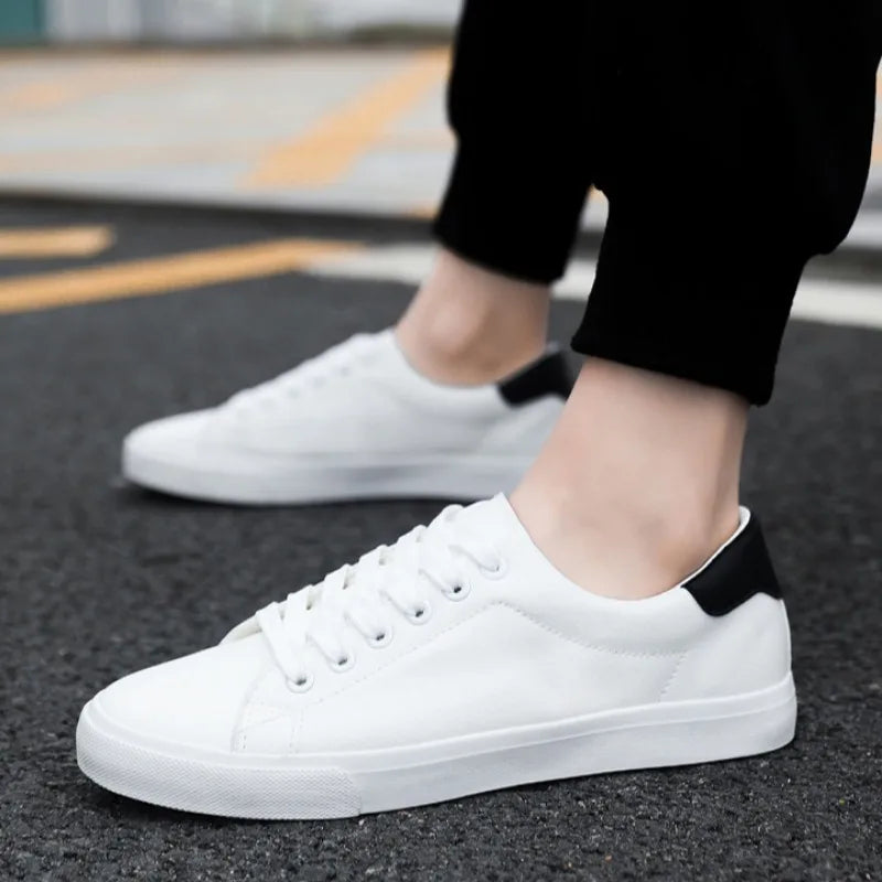 Men's classic white low-top lace-up sneakers for casual everyday wear. Comfortable men's fashion footwear.