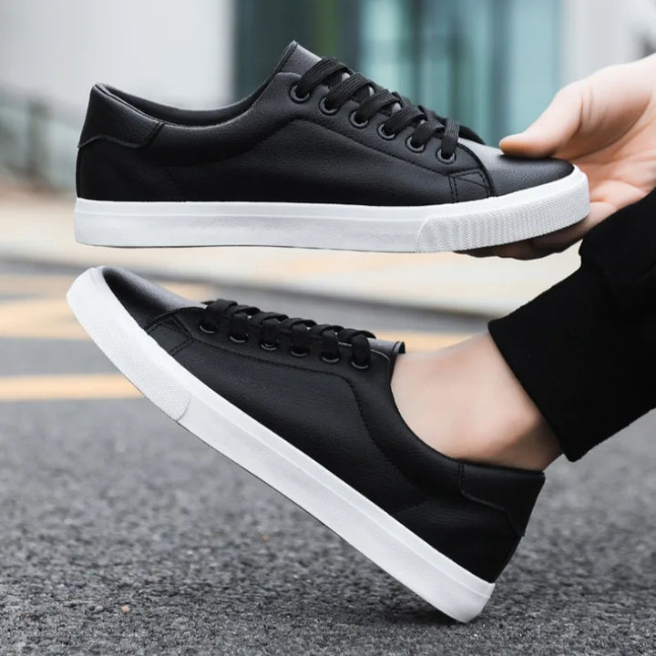 Versatile black men's low-top lace-up sneakers, ideal for casual outfits & everyday comfort. Stylish men's kicks.