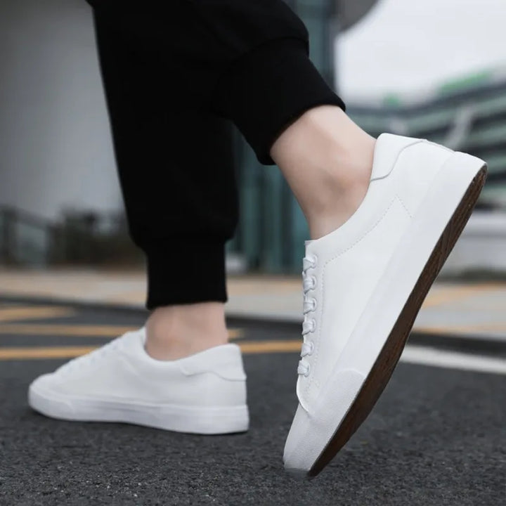 Modern grey men's low-top lace-up sneakers, offering comfort and athletic style for versatile everyday fashion.