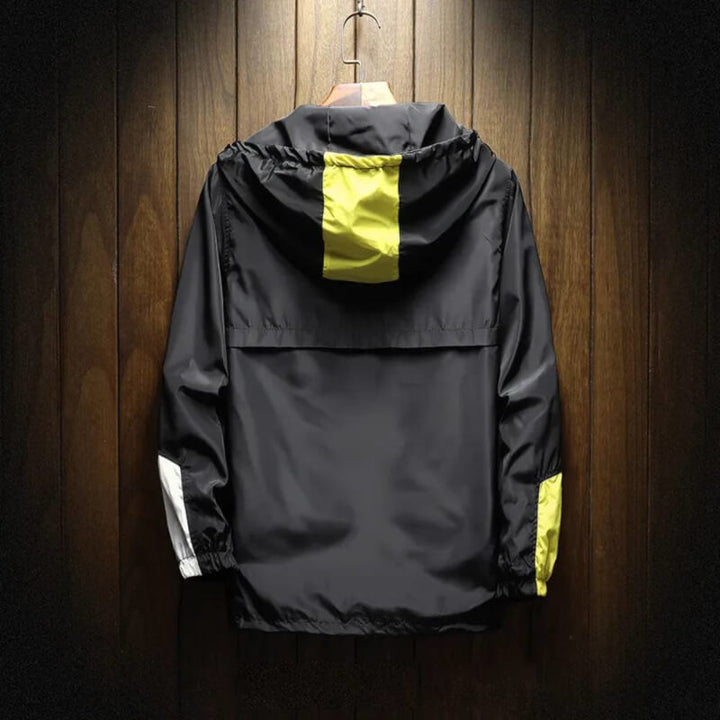 Modern men's hooded half-zip windbreaker jacket. Features a distinctive color block design, perfect for men's fashion.