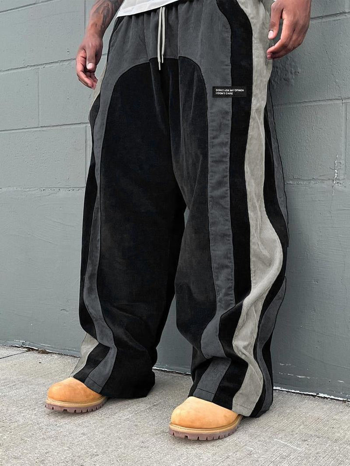 Men's tapered corduroy track pants with a distinctive color-block detail, offering comfort and style.