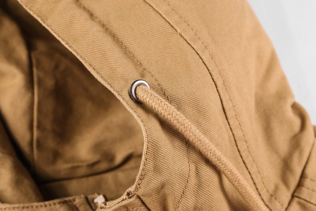 Hanger shot of a men's military-style cotton surplus jacket, ready for wear