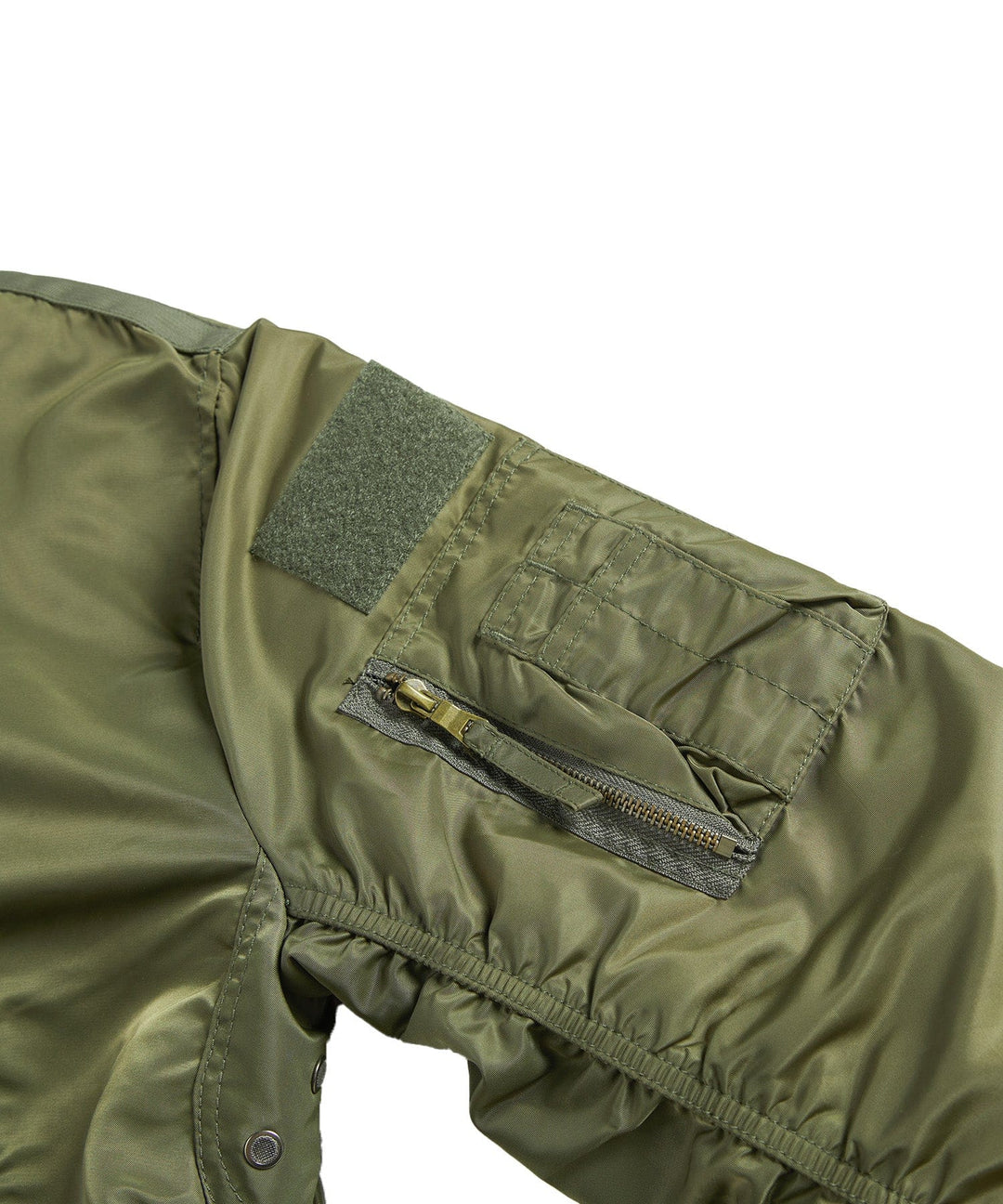 A stack of folded men's utility bomber jackets in various colors: olive, black, and navy.