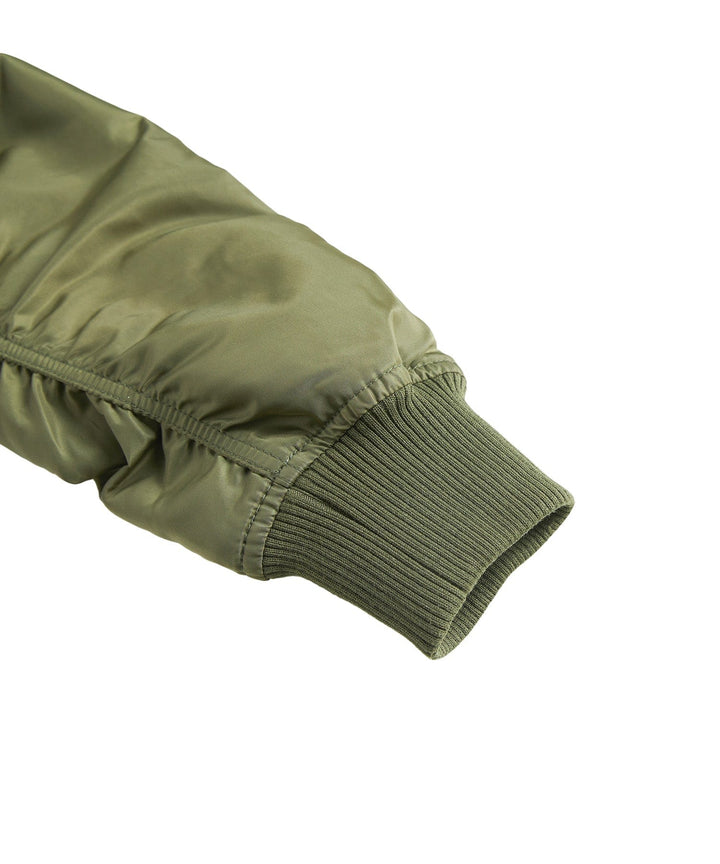 Man zipping up his men's durable bomber jacket, emphasizing its practicality and weather resistance.