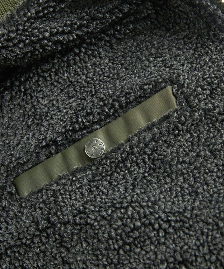 Product shot of the men's bomber jacket laid flat, showcasing its utility pockets and overall design.