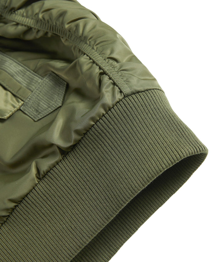 Close-up of the ribbed waistband and bottom hem of the men's durable utility bomber jacket.