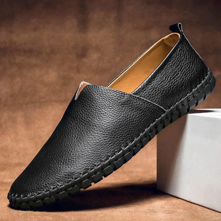 Elegant matte men's loafers on a foot, demonstrating comfortable fit and stylish appearance.