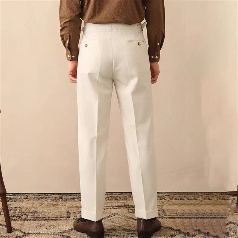 Modern men's pleated high-waisted pants with an adjustable side buckle detail for a tailored fit.
