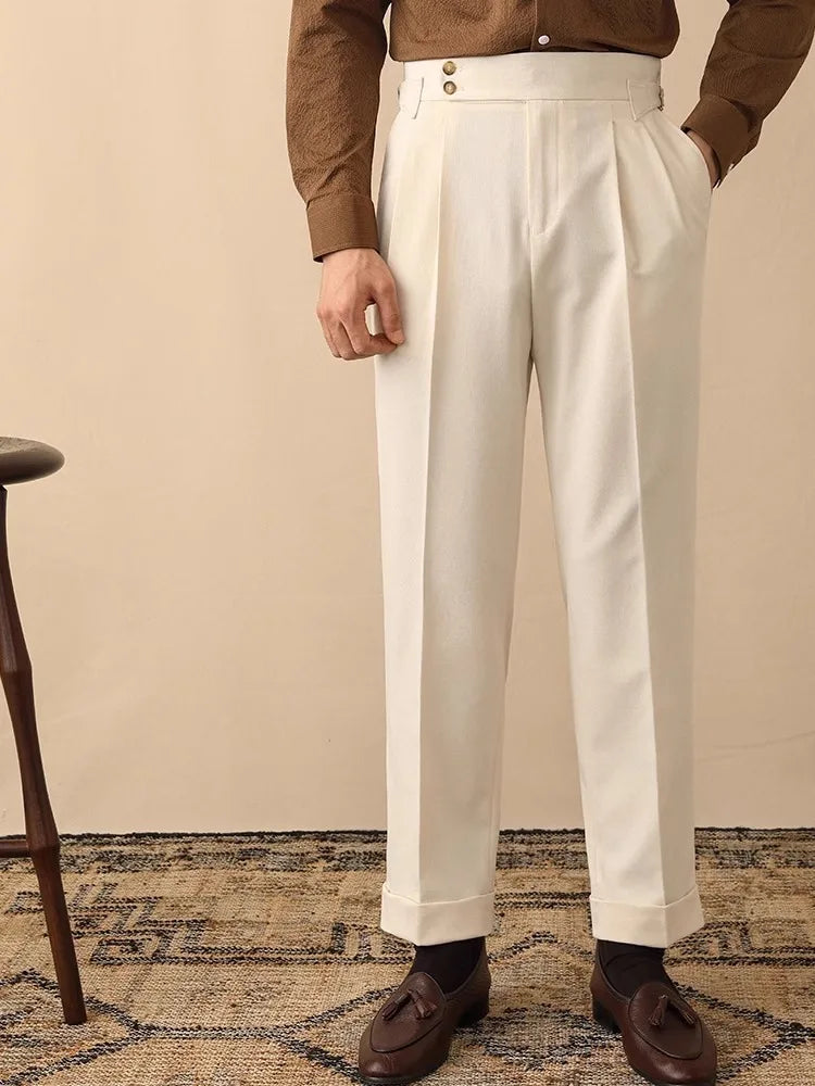 Close-up of men's high-waisted trousers, showing the elegant side buckle and tailored fabric.