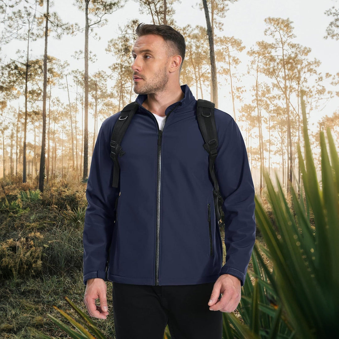 Fashionable man posing in a beige lightweight bomber jacket for a modern look.