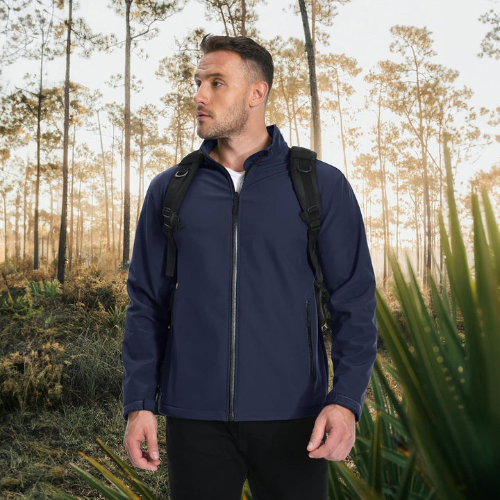 Fashionable man posing in a beige lightweight bomber jacket for a modern look.