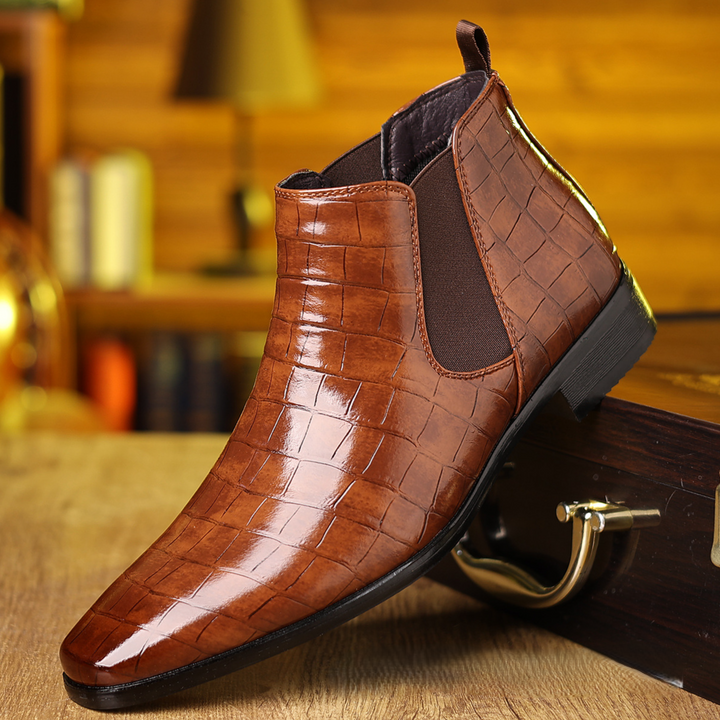 Close-up of men's elegant croc-embossed Chelsea boots, showcasing luxury texture & slip-resistant design for fashion.
