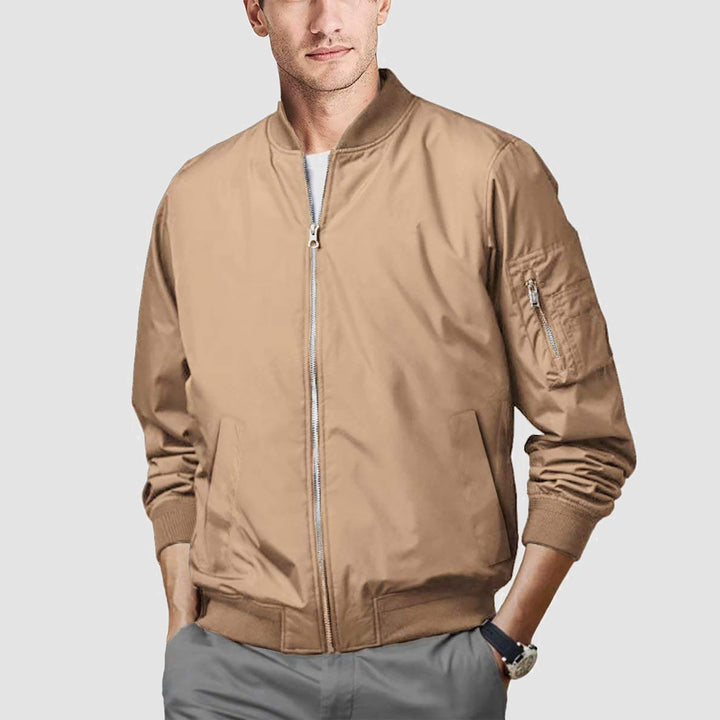 Abstract shot of men's bomber jacket detail, focusing on stitching and construction quality
