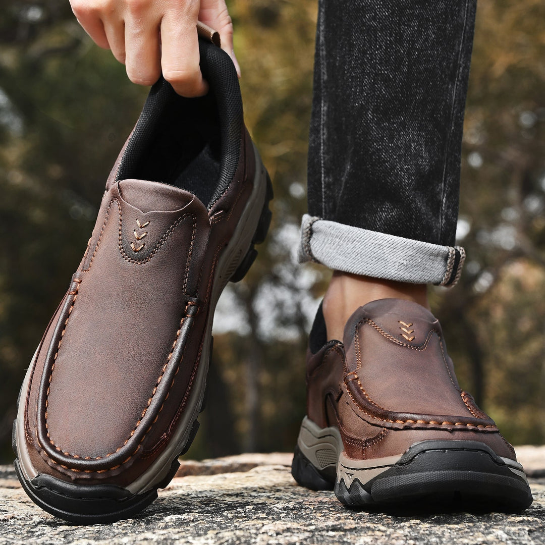 Outdoor shot of men's casual orthopedic leather slip-on walking shoes on a path