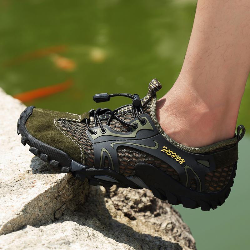 Men's outdoor hiking shoes displayed with hiking gear, ready for a challenging trek
