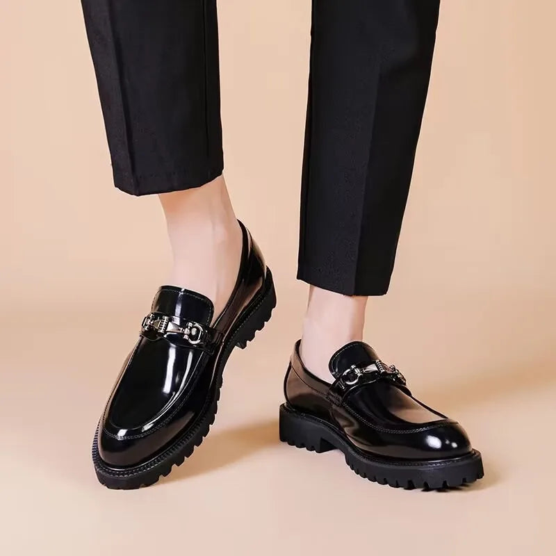 View of the durable sole on men's polished black leather loafers. Quality classic formal slip-on footwear.