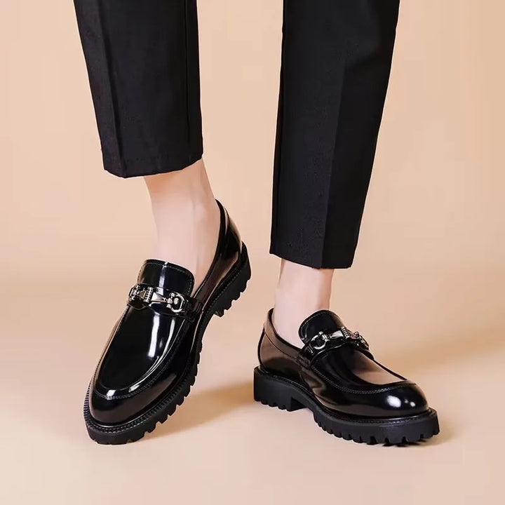 View of the durable sole on men's polished black leather loafers. Quality classic formal slip-on footwear.