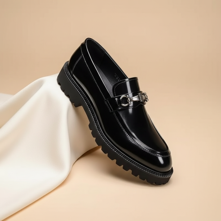 Men's polished burgundy leather loafers featuring a sophisticated metal bit detail. Classic formal footwear.